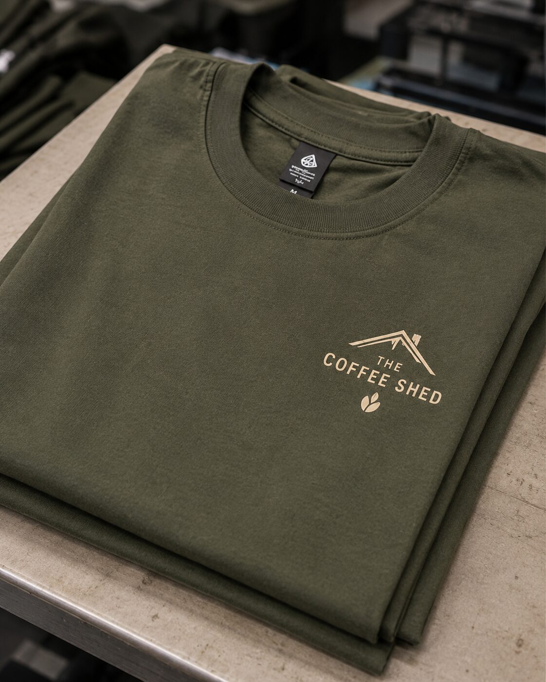 Left chest DTF transfer on a folded olive t-shirt